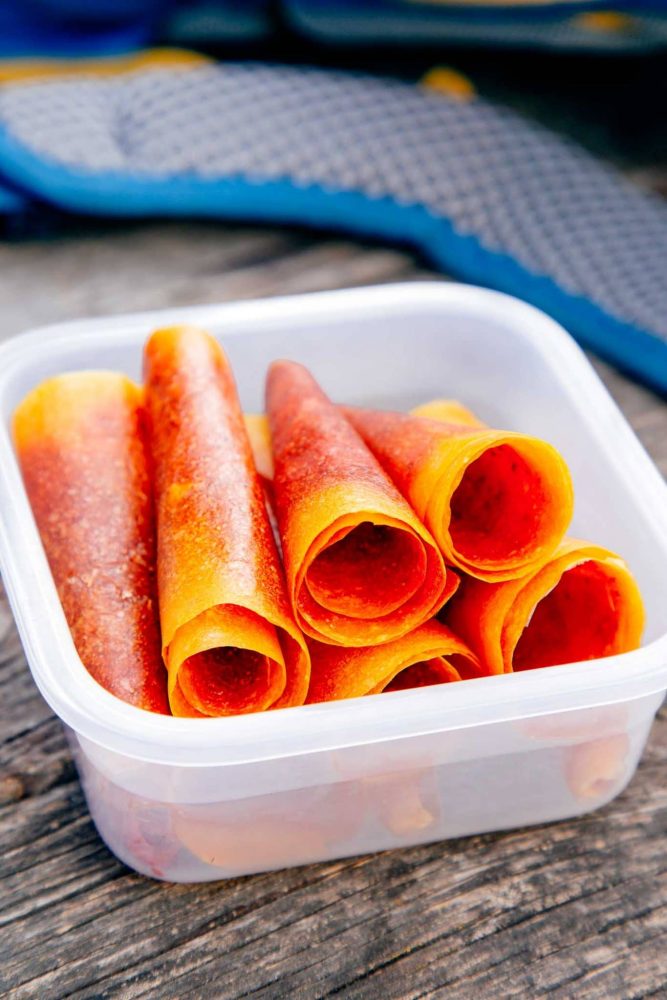 mango strawberry fruit leather rolled up in a plastic container