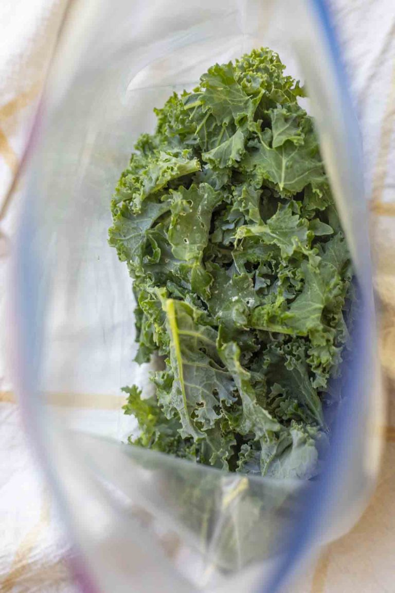 a plastic ziplock bag opened with frozen kale inside