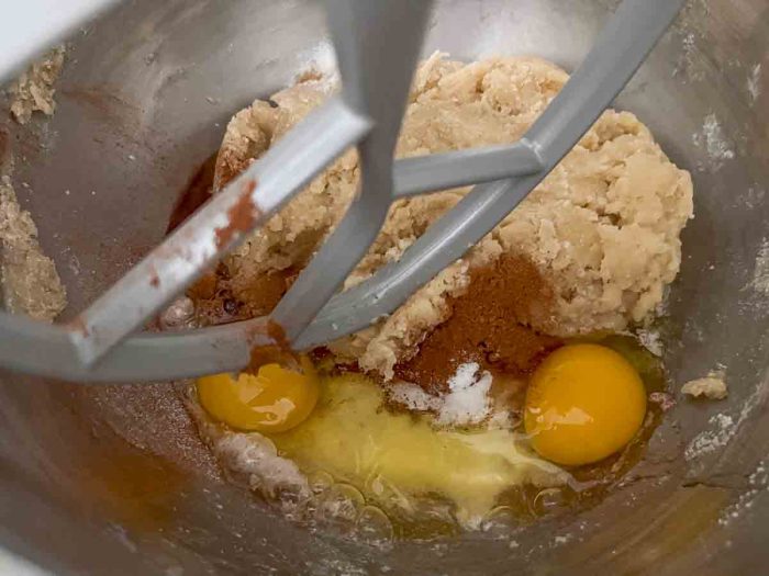 fermented dough, eggs, cinnamon, baking soda, and baking powder in a stand mixer bowl
