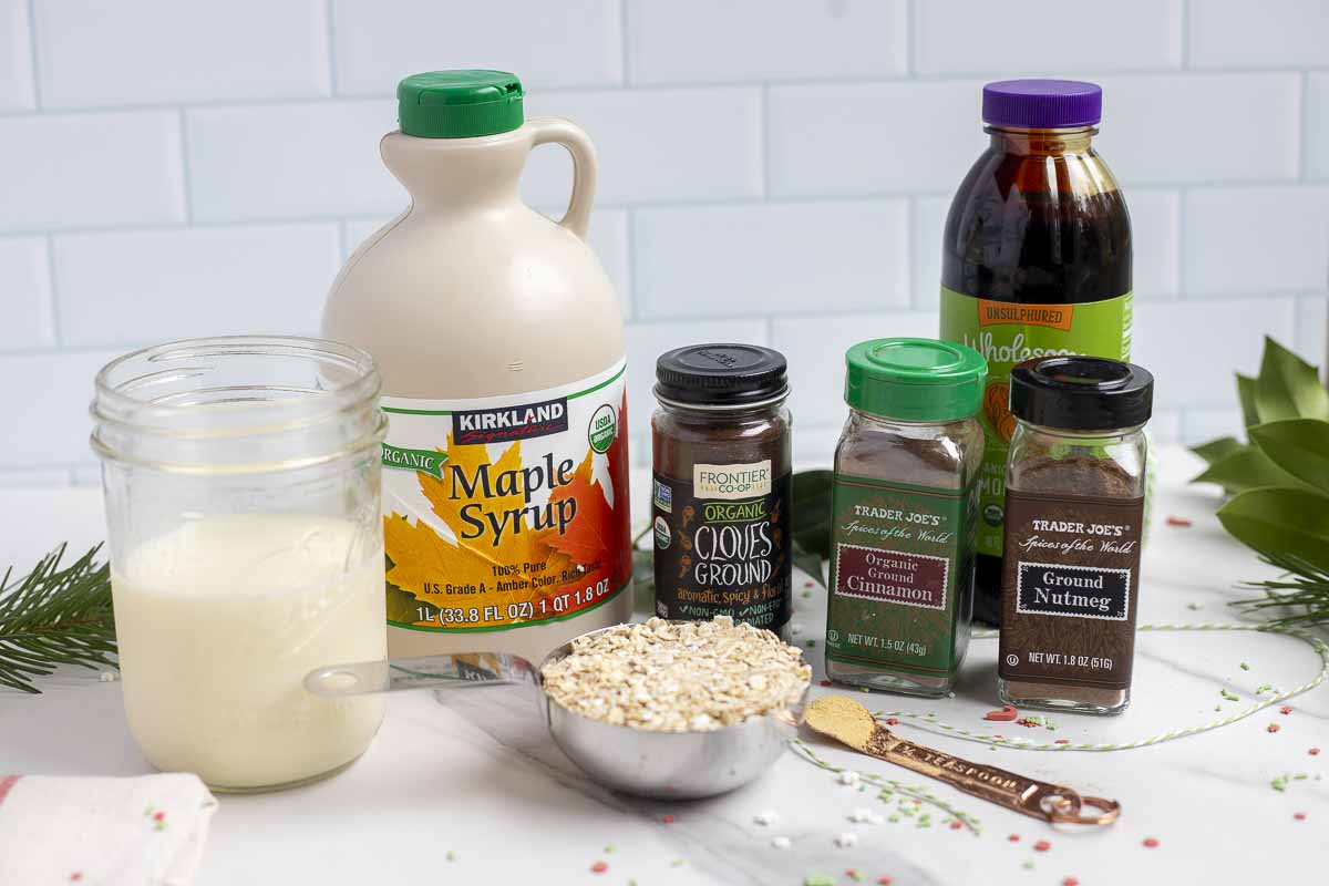 jars, containers, and measuring cups of ingredients on a marble countertop.