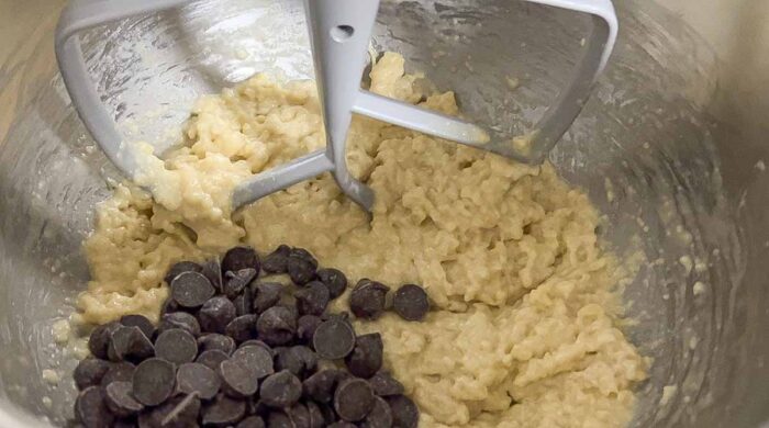 chocolate chips added to a stand mixer bowl with bread batter