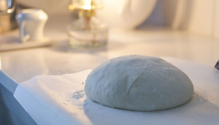 sourdough bread boule on parchment paper.