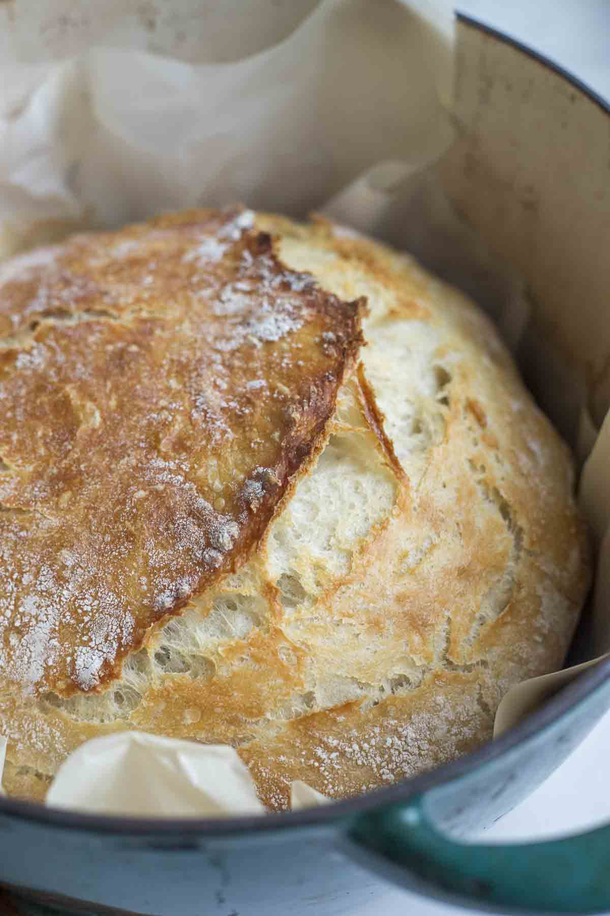 Sourdough bread in a dutch oven with parchment paper.