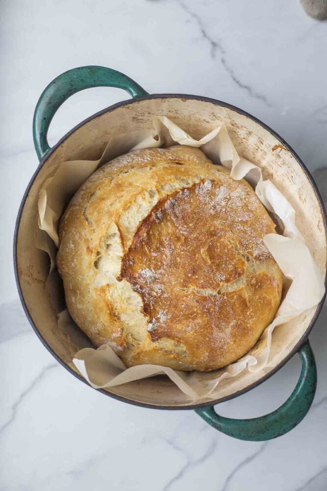 Easy sourdough bread in a parchment lined dutch oven.