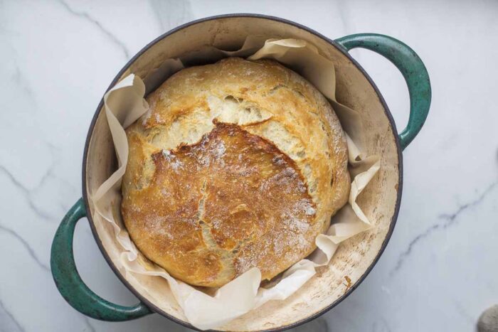 Easy sourdough bread in a parchment lined dutch oven.