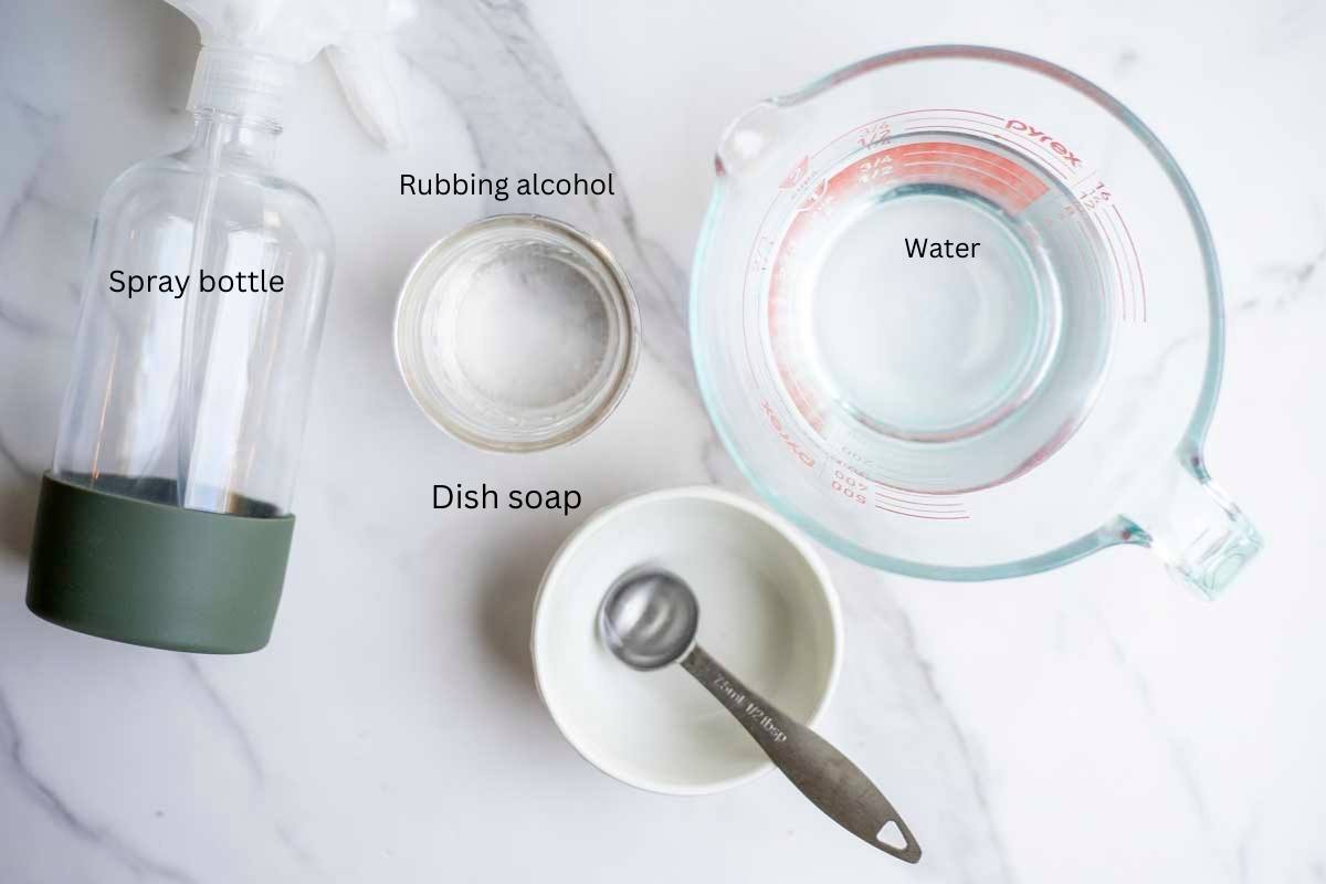 water, rubbing alcohol, and dish soap in containers with a spray bottle to the left.