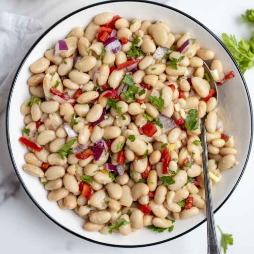 overhead photo of a bowl of white bean salad.