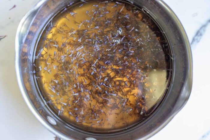 Lilac blossoms being steeped syrup. 
