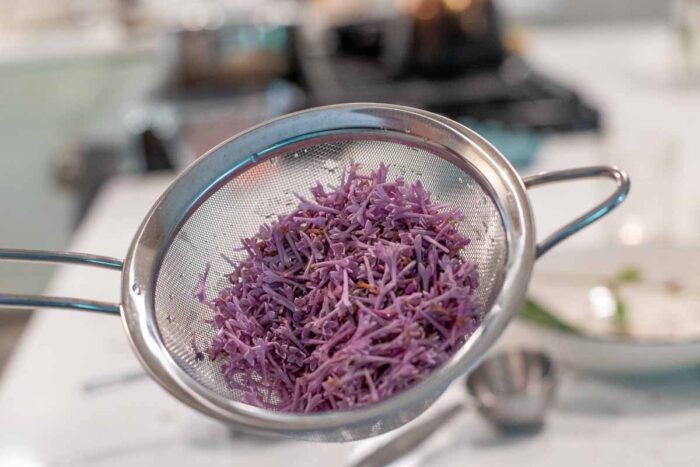 washed lilacs in a fine mesh strainer.