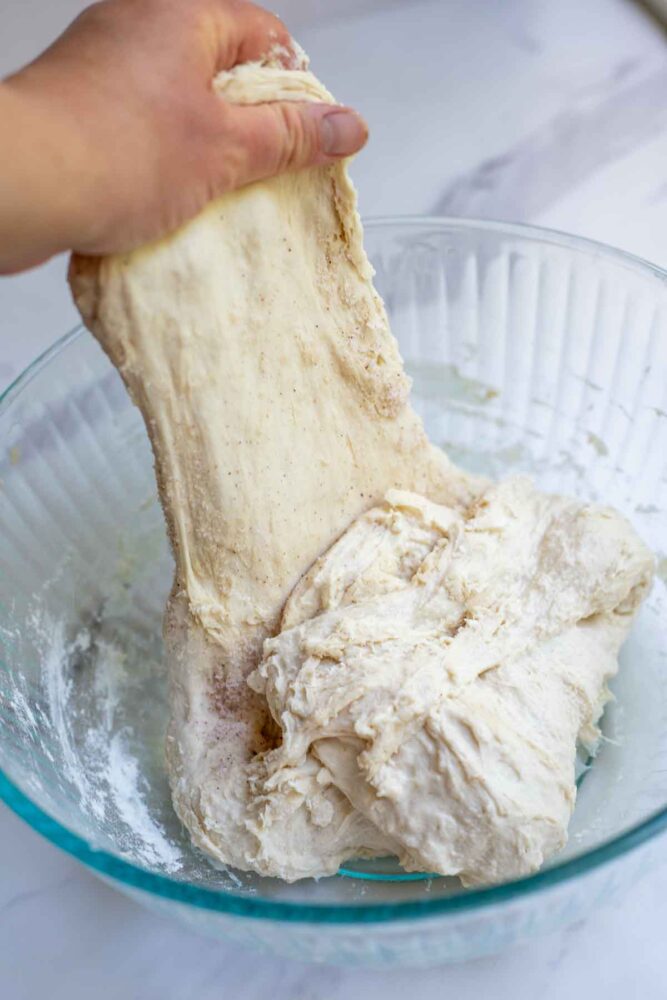 Pulling dough up to perform a stretch and fold.