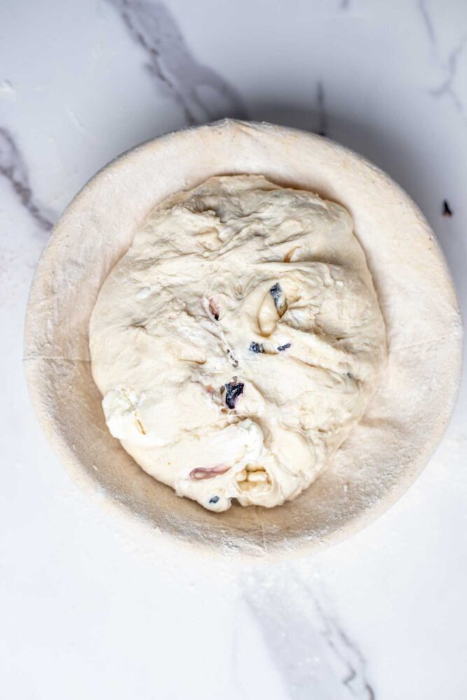 Sourdough blueberry bread in a banneton basket.