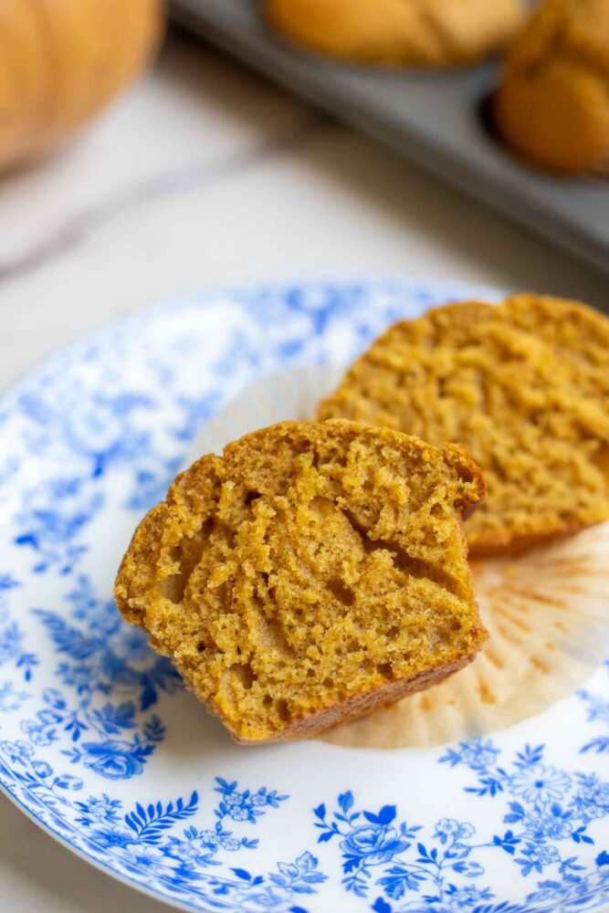 Sourdough pumpkin muffin cut in half revealing a super soft and fluffy interior.