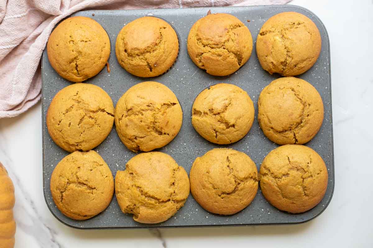 Sourdough pumpkin muffins baked in a muffin tin.