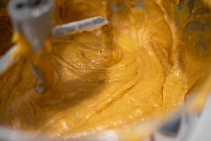 Sourdough pumpkin muffin batter mixed together in a stand mixer bowl.