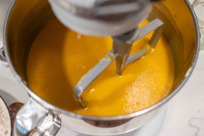 Pumpkin puree, eggs, starter and a few other ingredients in a stand mixer bowl.
