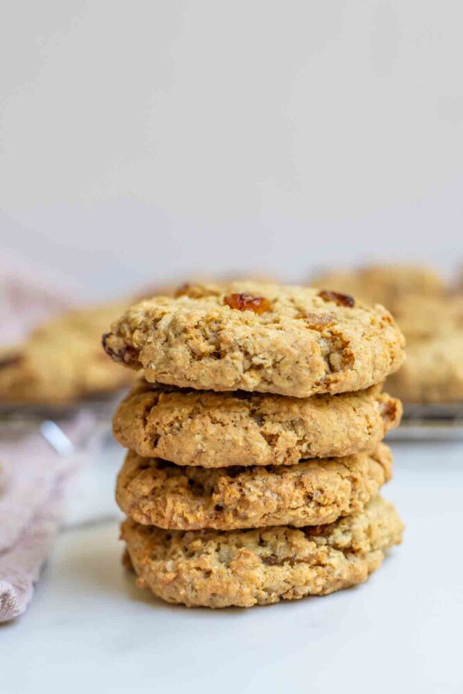 Sourdough oatmeal cookies stacked up on a countertop.