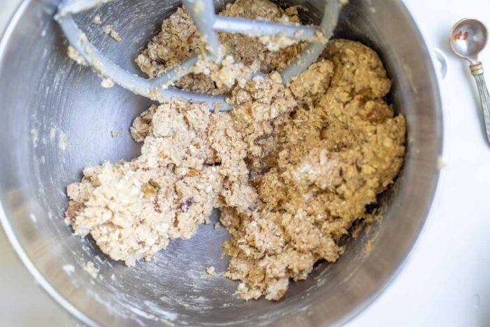 Sourdough oatmeal cookie dough mixed together in a stand mixer.