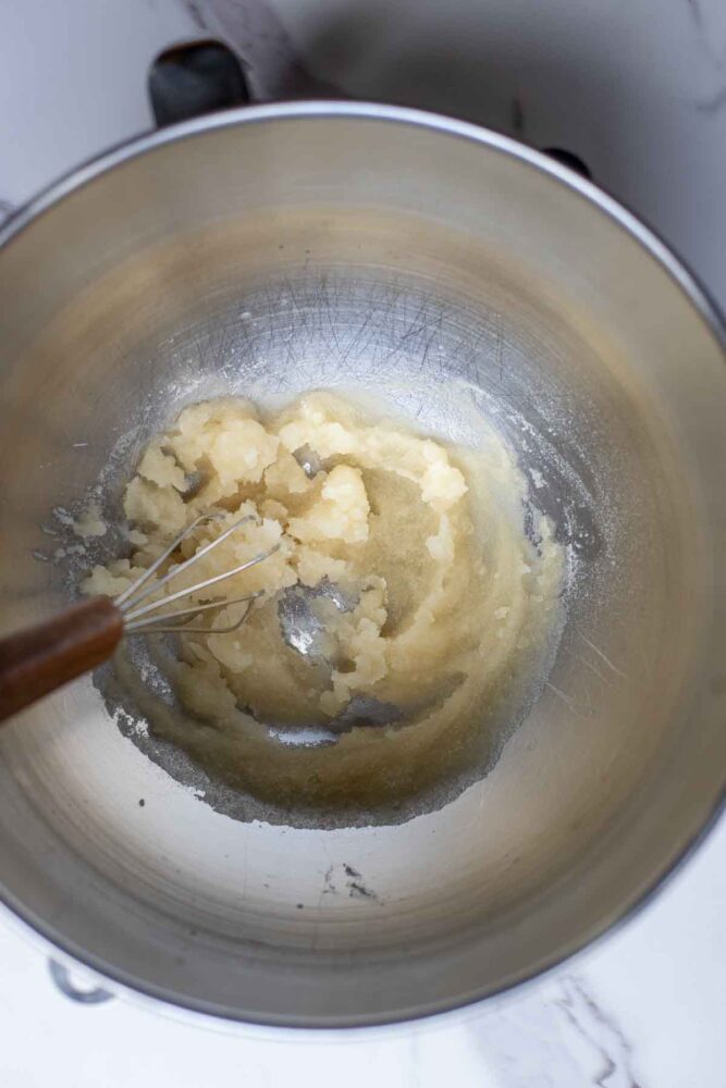 Gelatin and water mixed together in a stand mixer bowl.