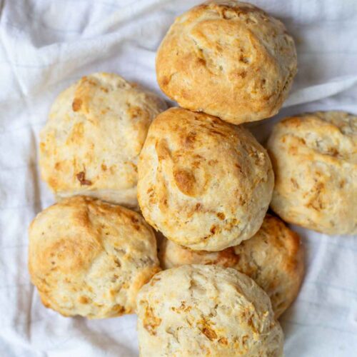 Sourdough drop biscuits piled up on a tea towel.