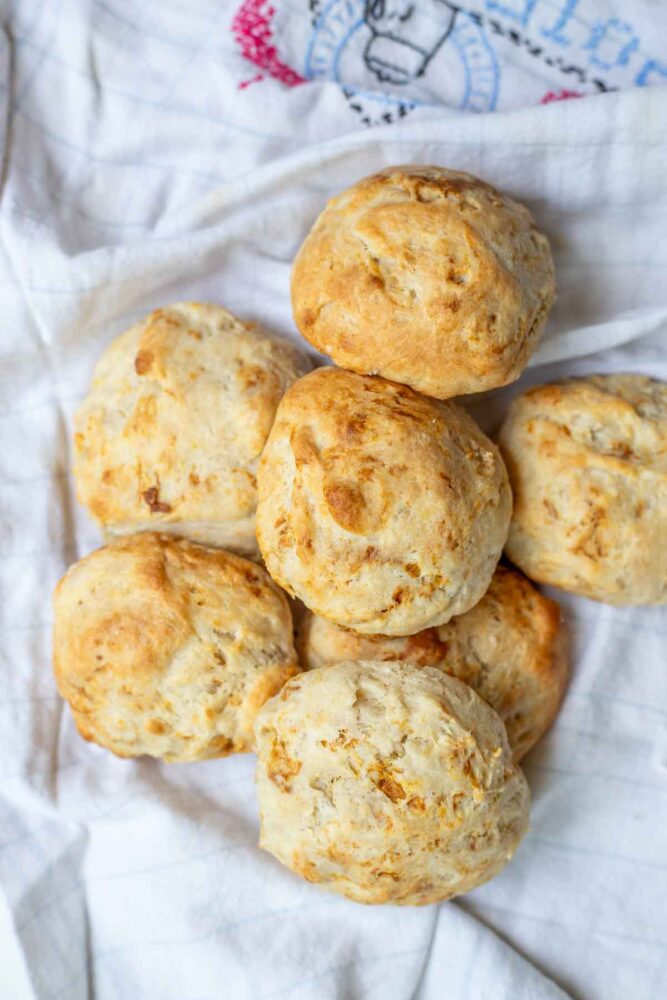 Sourdough drop biscuits piled up on a tea towel.