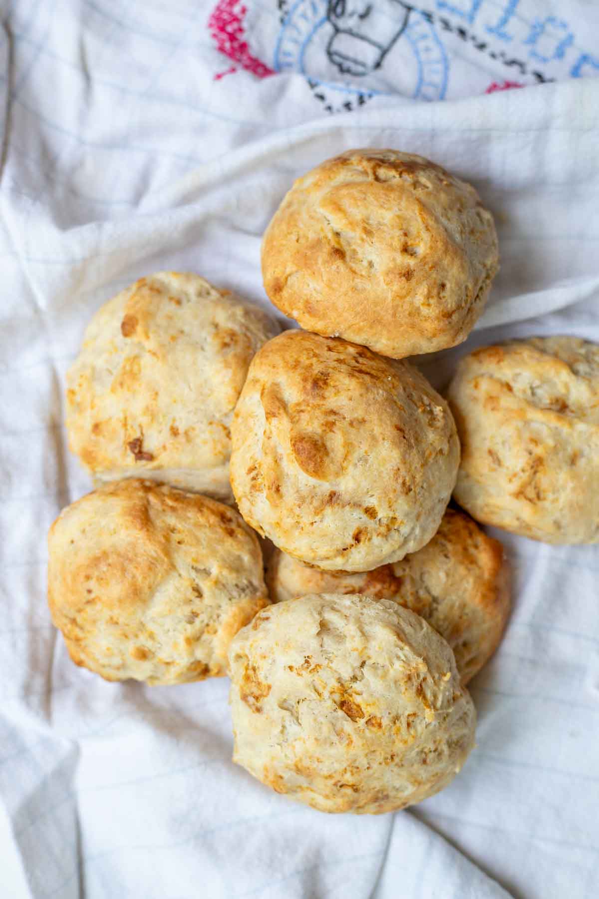 Sourdough drop biscuits piled up on a tea towel.