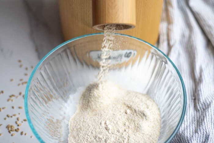 milling flour into a glass bowl.