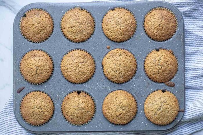 Whole wheat sourdough blueberry muffins baked in a muffin pan.
