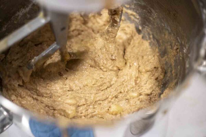 Whole wheat sourdough banana bread batter mixed together in a stand mixer.