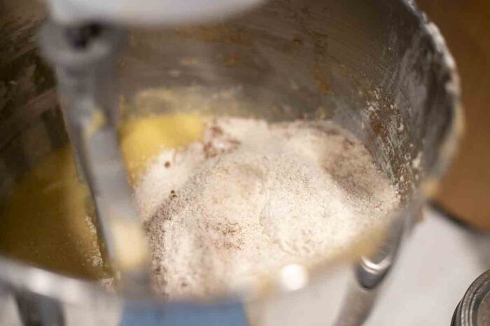 Dry ingredients added to  the wet ingredients in a stand mixer.