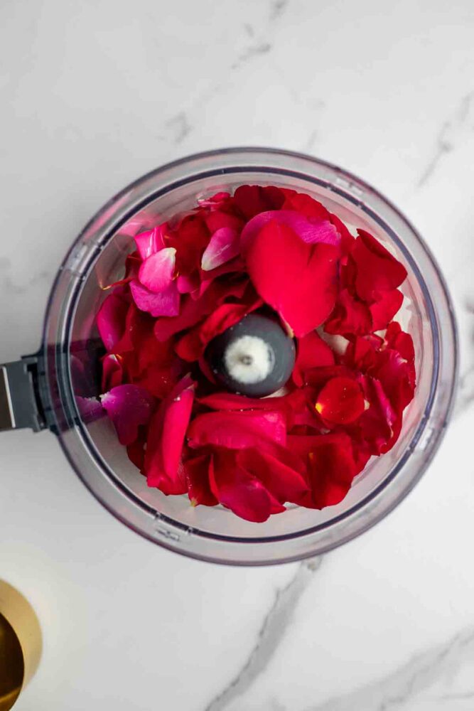 Sugar and rose pedals in a food processor.