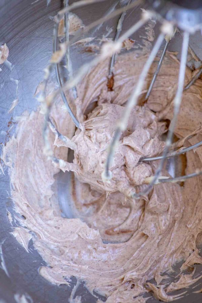 Cinnamon honey butter whipped in a stand mixer bowl with whisk attachment.