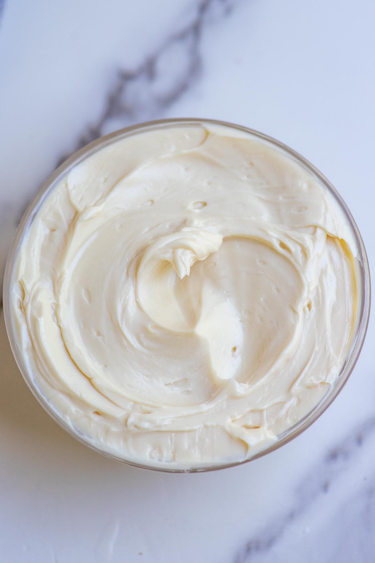 Overhead photo of pure maple butter in a glass bowl.