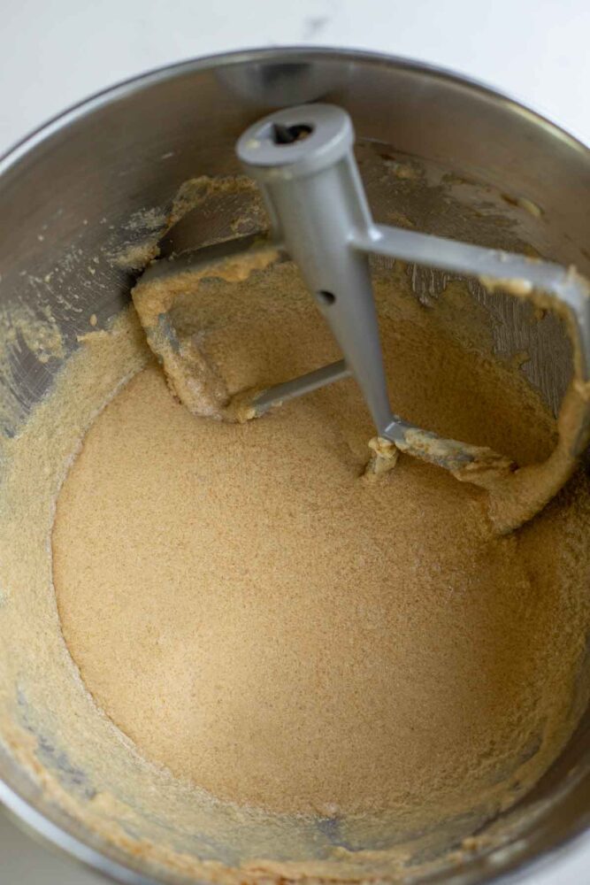 Butter, sugar, sourdough starter, eggs and vanilla in a stand mixer bowl.