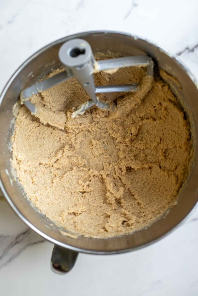 Creaming butter and sugar together in a bowl of a stand mixer.
