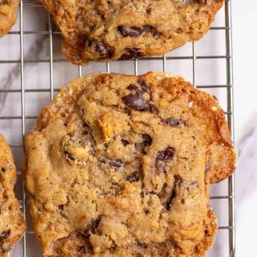 A close up picture of a sourdough s'mores cookie on a cooling rack.