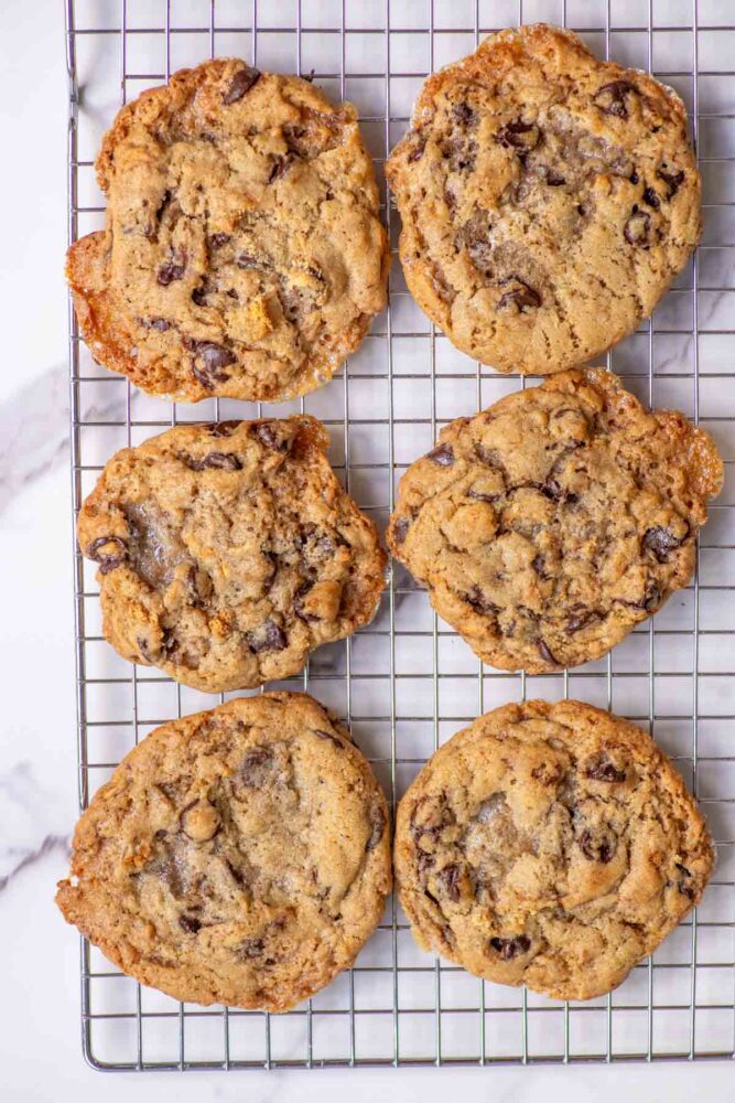 six sourdough s'mores cookies on a wire rack.