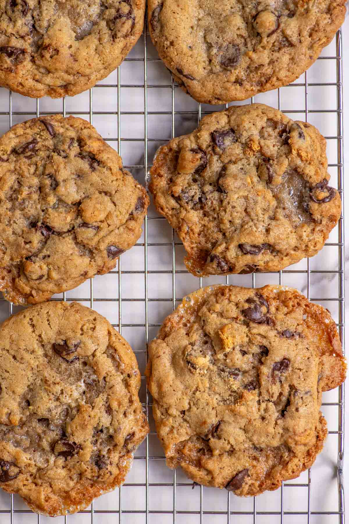 six sourdough s'mores cookies on a wire rack.
