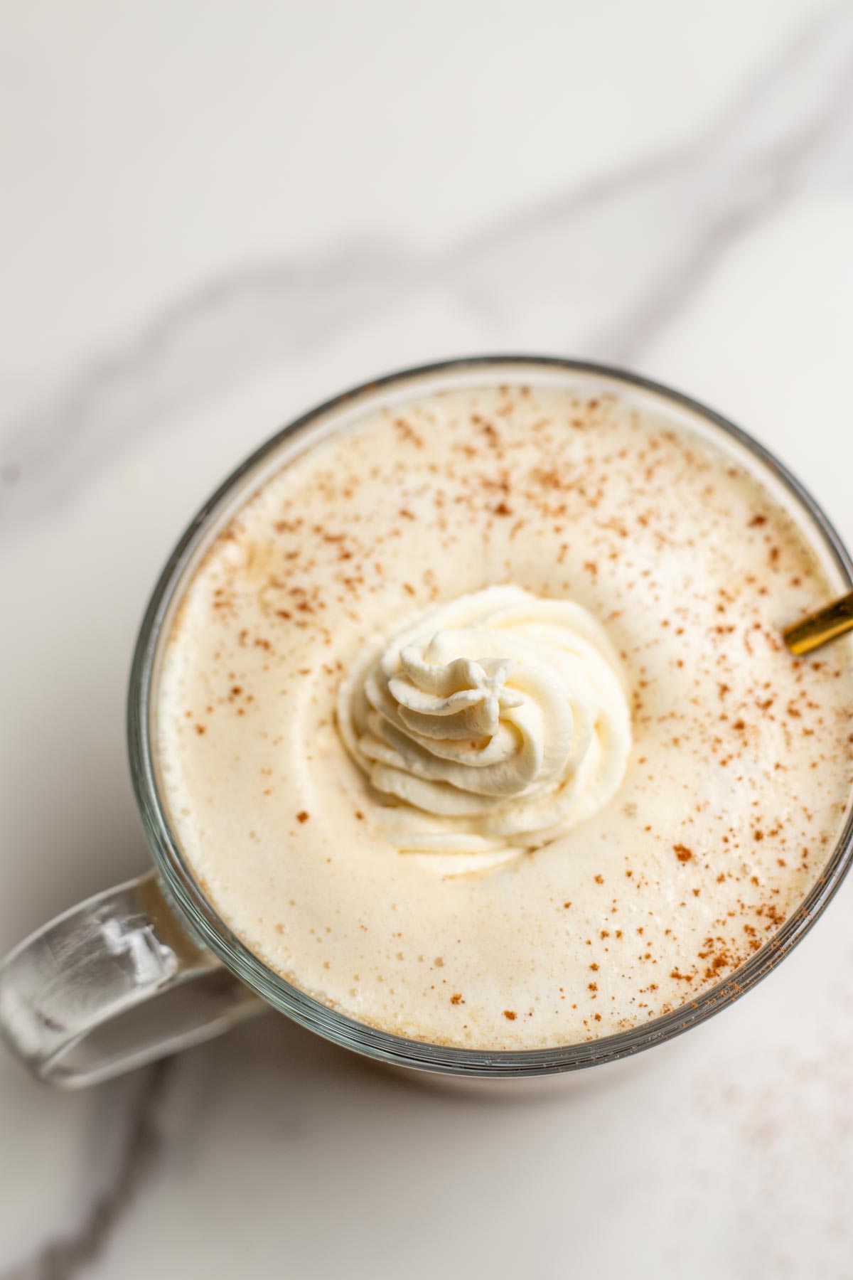 Overhead photo of a maple latte with whipped cream.