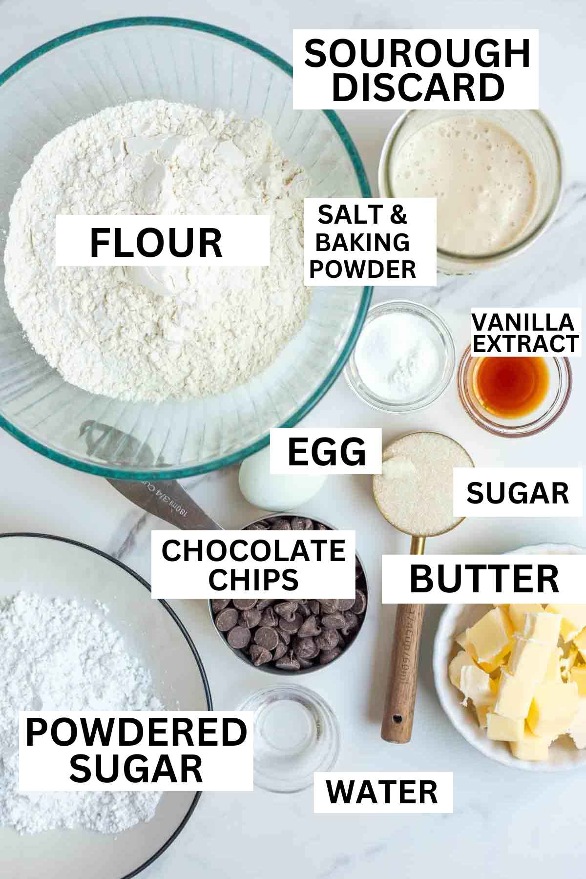 Flour, butter, discard, and other ingredients on a countertop.