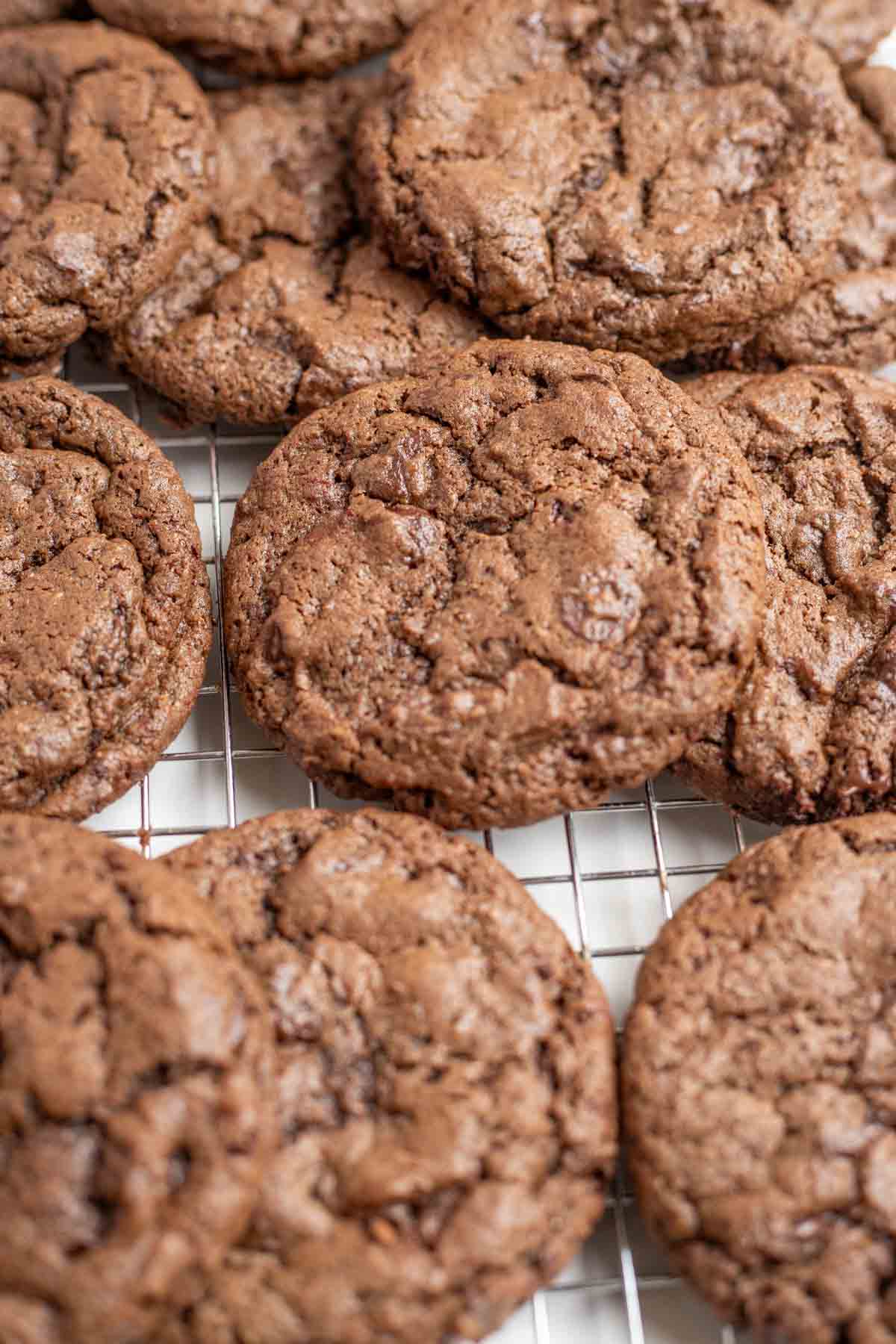 Double chocolate sourdough cookies on a cooling rack.