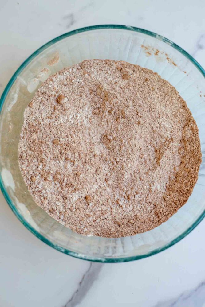 Flour, cocoa powder, salt, cornstarch, and leavens in a glass bowl.
