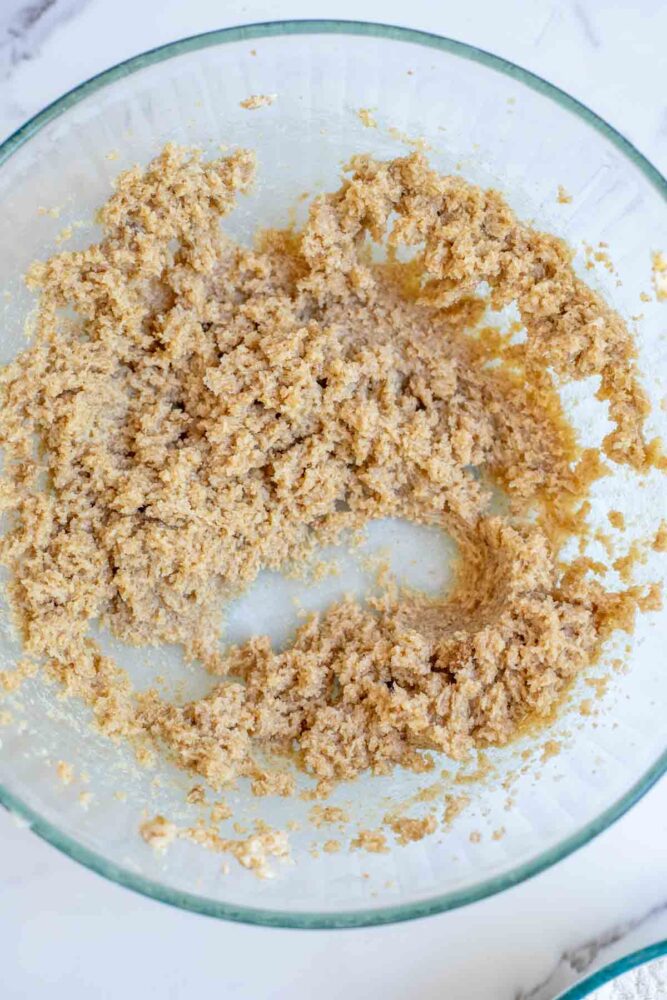 Creaming sugar and butter together in a glass bowl.