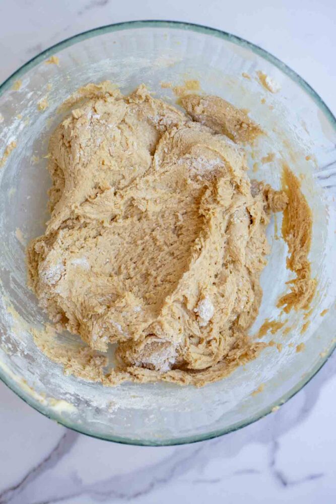 Dry ingredients added to wet ingredients in glass bowl.