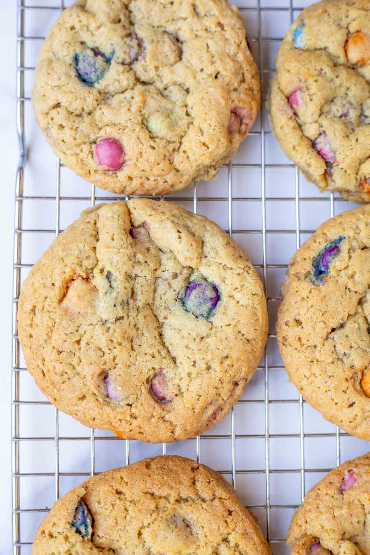 Sourdough M&M cookies on a wire rack.