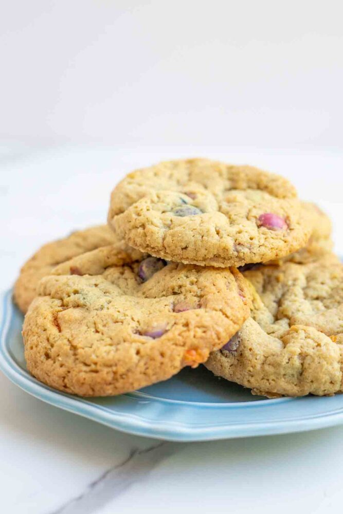 Sourdough m&m cookies stacked on a blue plate.