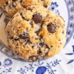 Close up of two sourdough chocolate chip scones make with discard on a white plate.