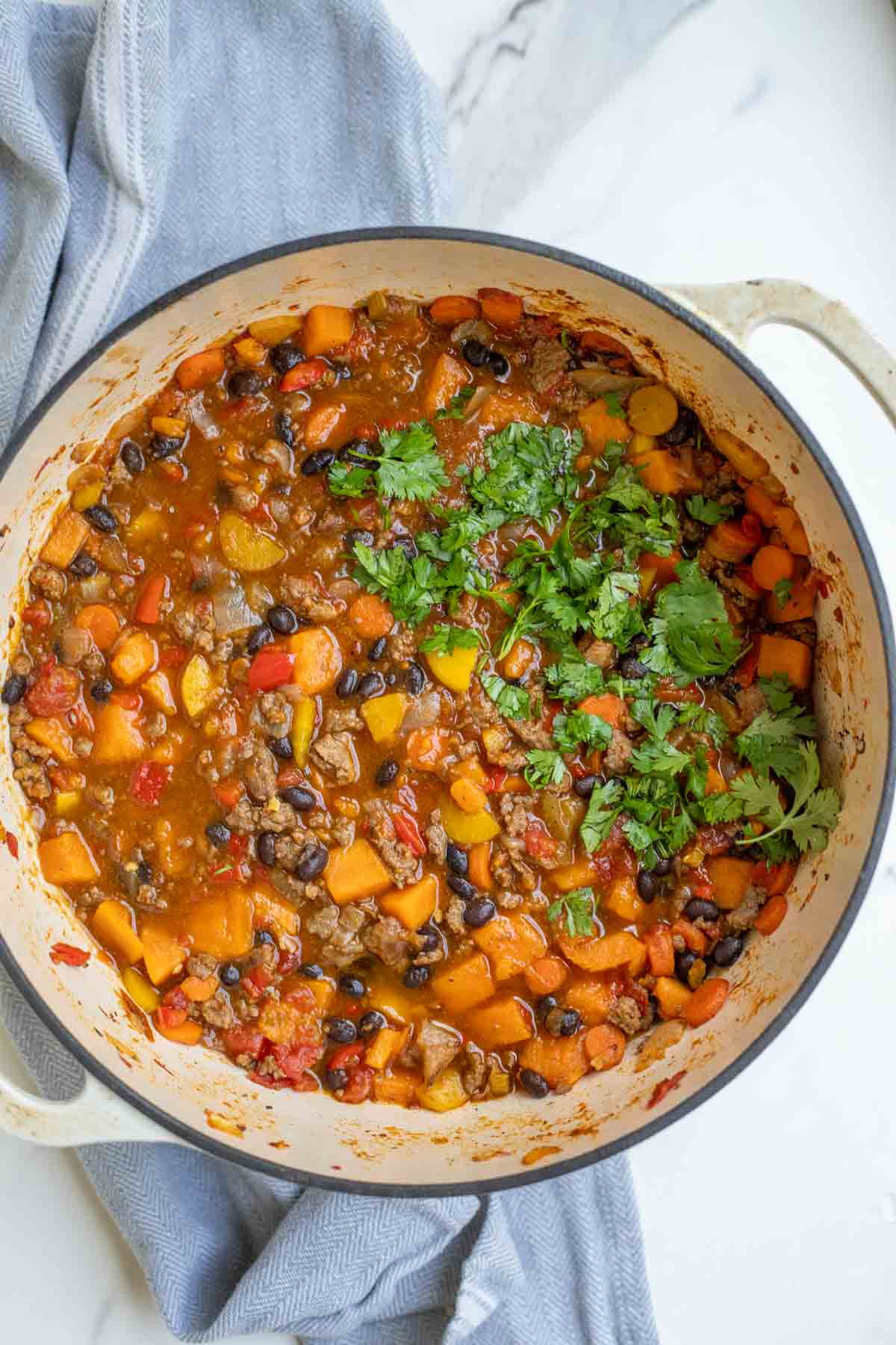 Overhead photo of a pot of sweet potato chili topped with cilantro.