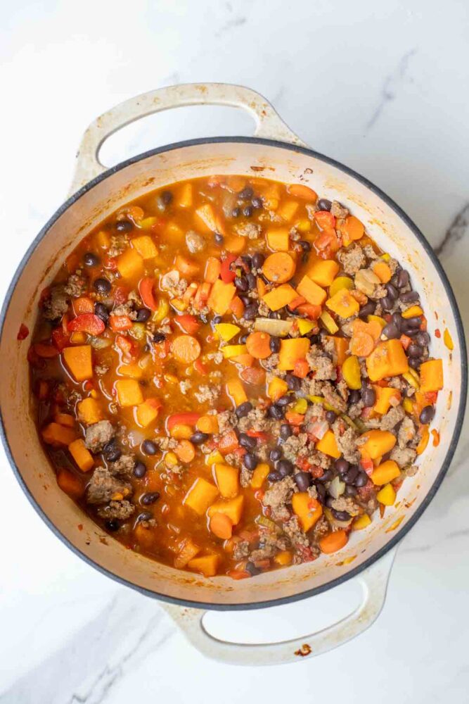 Sweet potato chili with ground beef and black beans in a pot.