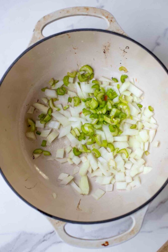 Dutch oven with onions and celery.