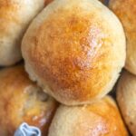 Close up picture of whole wheat burger buns stacked in a basket.